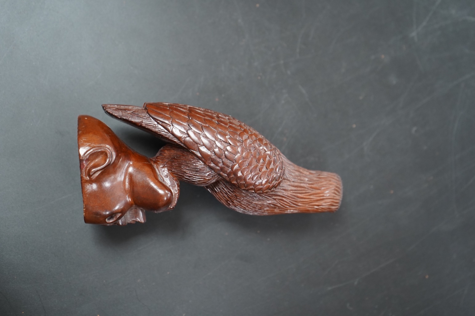 A Chinese rosewood carving of a hawk on base, with inlaid glass eyes, 13cm high